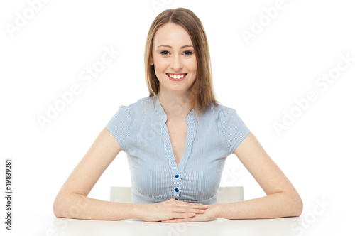 Photo: Young woman leaning arms on table Young woman leaning arms on table