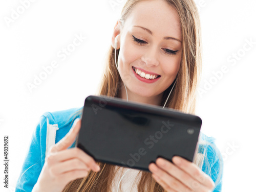 Photo: Female teenager using digital tablet Female teenager using digital tablet