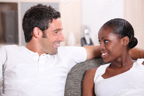 Photo: Couple sitting on sofa Couple sitting on sofa