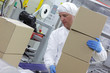 manual worker at production line dealing with boxes