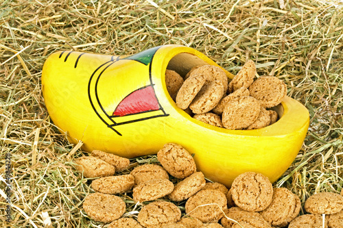 Photo: Traditional dutch wooden clog with gingernuts in straw Traditional dutch wooden clog with gingernuts in straw