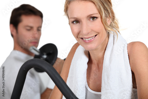 Photo: Man and woman working out in gym Man and woman working out in gym