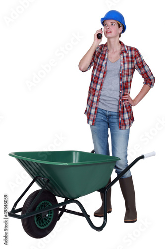Photo: Woman with wheelbarrow and radio receiver Woman with wheelbarrow and radio receiver