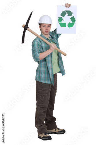 Photo: Man with pick-axe holding recycle logo Man with pick-axe holding recycle logo