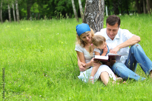 Photo: family with a young daughter reads the Bible family with a young daughter reads the Bible