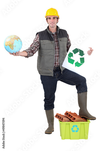 Photo: Worker holding globe Worker holding globe