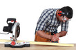 Carpenter marking wood before sawing