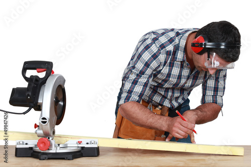 Photo: Carpenter marking wood before sawing Carpenter marking wood before sawing
