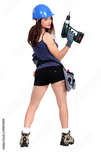 Photo: sexy craftswoman holding a drill sexy craftswoman holding a drill