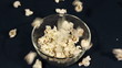 Popcorn falls in a glass cup. Close up scene