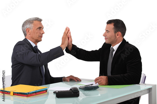 Photo: business partners sitting at table business partners sitting at table