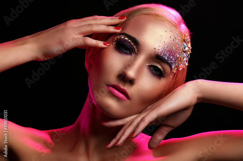 Photo: Portrait of beautiful woman with artistic makeup Portrait of beautiful woman with artistic makeup