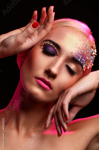 Photo: Portrait of beautiful woman with artistic makeup Portrait of beautiful woman with artistic makeup