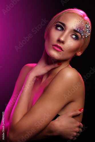 Photo: Portrait of beautiful woman with artistic makeup Portrait of beautiful woman with artistic makeup