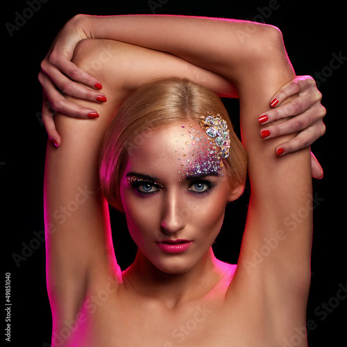 Photo: Portrait of beautiful woman with artistic makeup Portrait of beautiful woman with artistic makeup