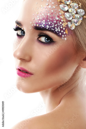 Photo: Closeup portrait of beautiful woman with artistic makeup Closeup portrait of beautiful woman with artistic makeup