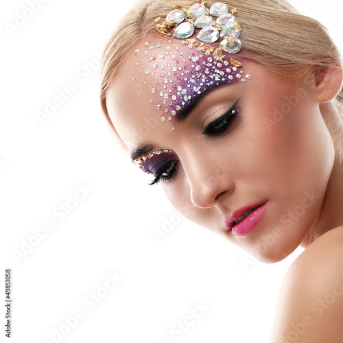 Photo: Closeup portrait of beautiful woman with artistic makeup Closeup portrait of beautiful woman with artistic makeup