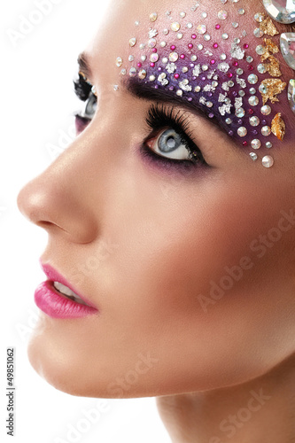 Photo: Closeup portrait of beautiful woman with artistic makeup Closeup portrait of beautiful woman with artistic makeup