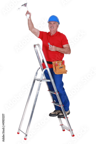 Photo: Electrician working on ceiling Electrician working on ceiling