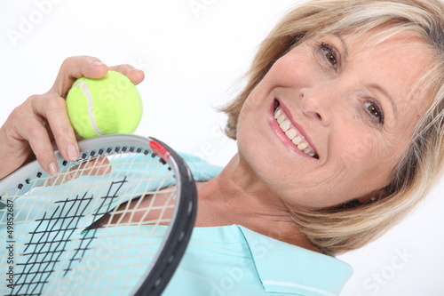 Photo: woman holding tennis racket and ball woman holding tennis racket and ball