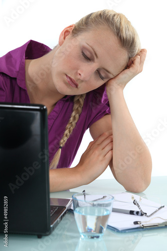 Photo: Woman asleep at her desk Woman asleep at her desk