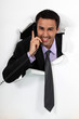 Office worker bursting through backdrop