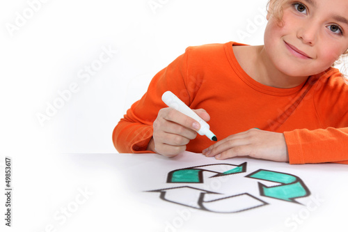 Photo: Girl colouring recycling sign Girl colouring recycling sign