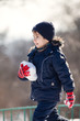 Cute boy playing with snow