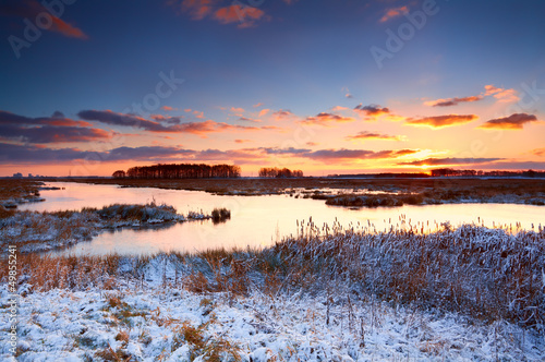 Photo: colorful sunrise over river in winter colorful sunrise over river in winter