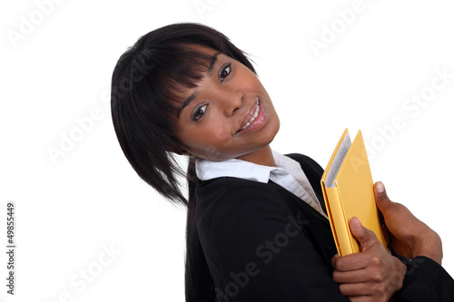 Photo: Businesswoman hugging a folder to her chest Businesswoman hugging a folder to her chest