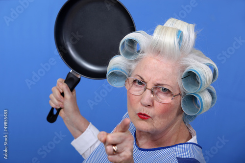 Photo: Angry old woman with a frying pan Angry old woman with a frying pan