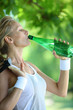 Sporty woman drinking water