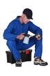 Plumber heating up pipe with blow torch