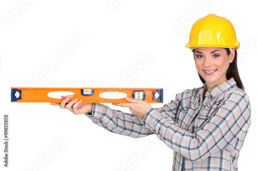 Photo: Tradeswoman holding a spirit level Tradeswoman holding a spirit level