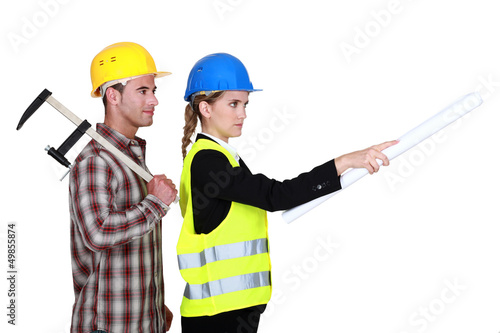 Photo: Tradesman following an engineer's orders Tradesman following an engineer's orders