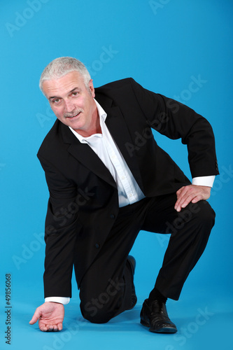 Photo: Businessman touching the floor Businessman touching the floor