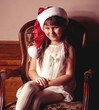Beautiful little girl in Santa Claus clothes