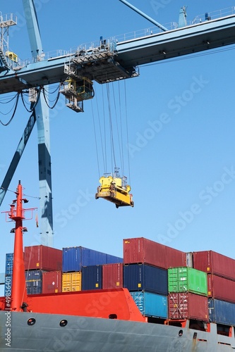 Photo: Container ship working with a crane in the port of Alicante Container ship working with a crane in the port of Alicante