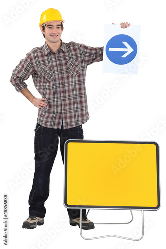 Photo: Man holding traffic sign Man holding traffic sign