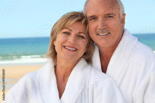 Photo: Couple at the beach in bathrobes Couple at the beach in bathrobes