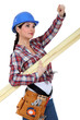 A female carpenter pointing at something.