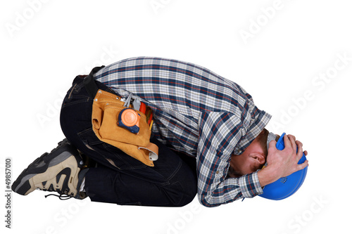 Photo: Construction worker curled up Construction worker curled up