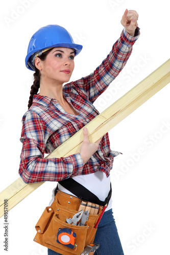 Photo: A female carpenter pointing at something. A female carpenter pointing at something.