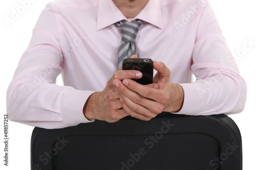 Photo: Businessman sat on chair backwards Businessman sat on chair backwards