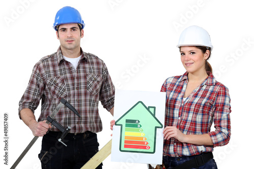 Photo: Construction workers holding an energy efficiency rating chart Construction workers holding an energy efficiency rating chart
