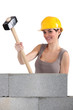 craftswoman holding a huge hammer