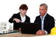 Architects with a laptop and 3D model