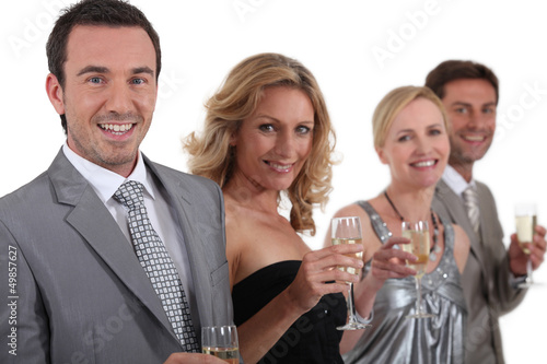 Photo: couples standing holding champagne couples standing holding champagne