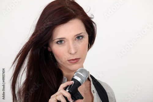 Photo: Brunette singer holding microphone Brunette singer holding microphone