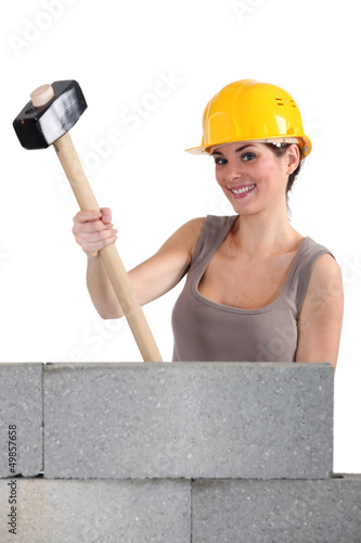 Photo: craftswoman holding a huge hammer craftswoman holding a huge hammer
